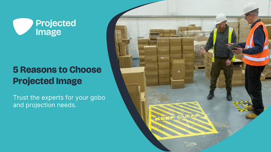 site visit in a warehouse with a projected safety sign on the floor