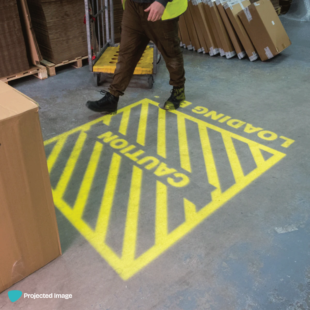Projected warehouse safety signage of a hatched marking and 'Loading Bay' text.