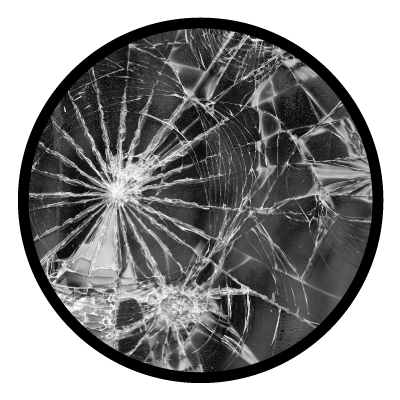 Greyscale image of a close up of a cracked mirror on a black circle gobo.