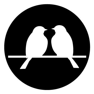 White silhouette of two birds sitting on a branch on a black circle gobo.
