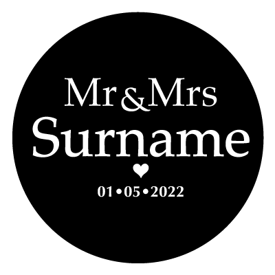 White "Mr & Mrs Surname" text with a small white heart below. Underneath the small heart is the text "01.05.2022" in white. All on a black circle.