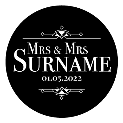 "Mrs & Mrs Surname" text with "01.05.2022" underneath. Above and below this text is an art deco style pattern. All white on a black circle.