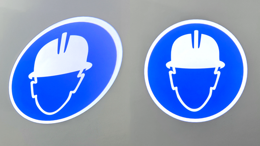 Before and after of a projected hard hat PPE sign, the sign on the left is distorted and the one on the right is a circle due to being keystone corrected.