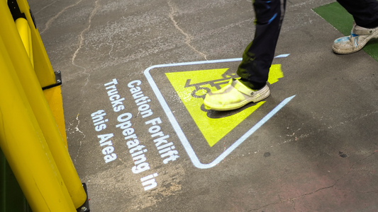 Projected forklift safety sign in a warehouse.