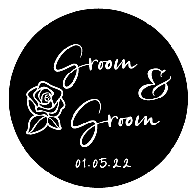 Stacked "Groom & Groom" text with a rose illustration to the left and "01.05.22". All white on a black circle.