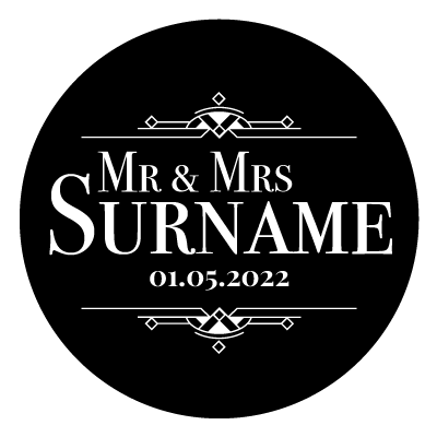 "Mr & Mrs Surname" text with "01.05.2022" underneath. Above and below this text is an art deco style pattern. All white on a black circle.