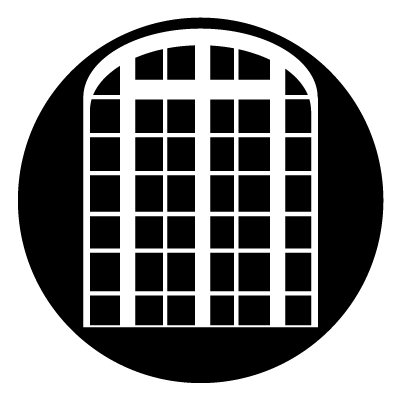 White arched window with grid design to create a French window. On a black circle.